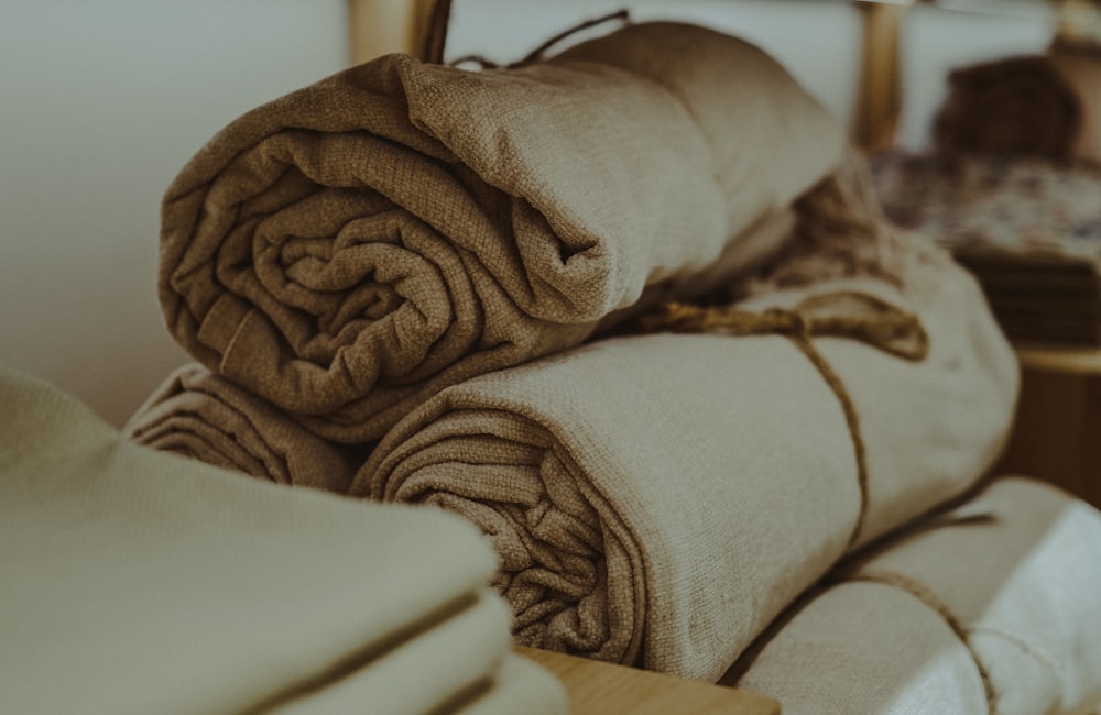 A neat stack of folded linens on a shelf